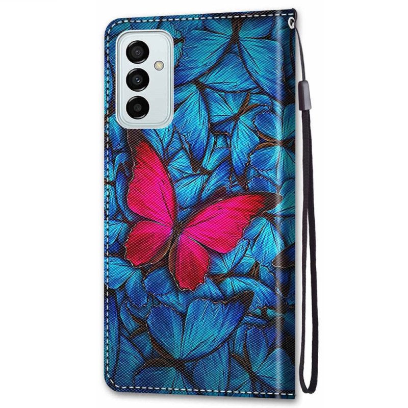 Lederhüllen Für Samsung Galaxy M23 5G Roter Schmetterling. Blauer Hintergrund