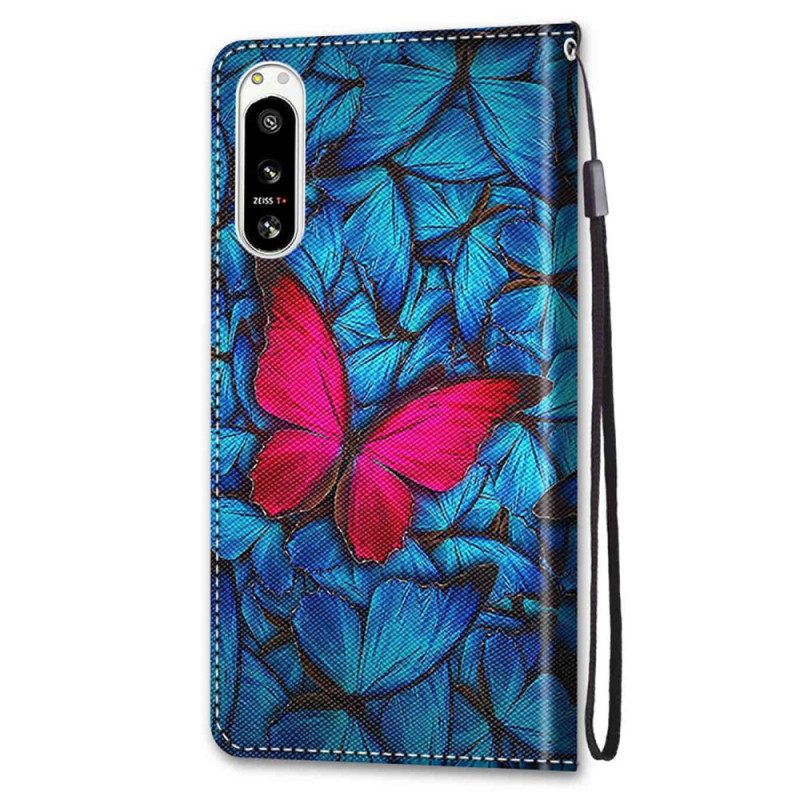 Lederhüllen Für Sony Xperia 5 IV Roter Schmetterling. Blauer Hintergrund