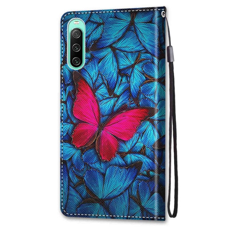 Flip Case Für Sony Xperia 10 IV Roter Schmetterling. Blauer Hintergrund